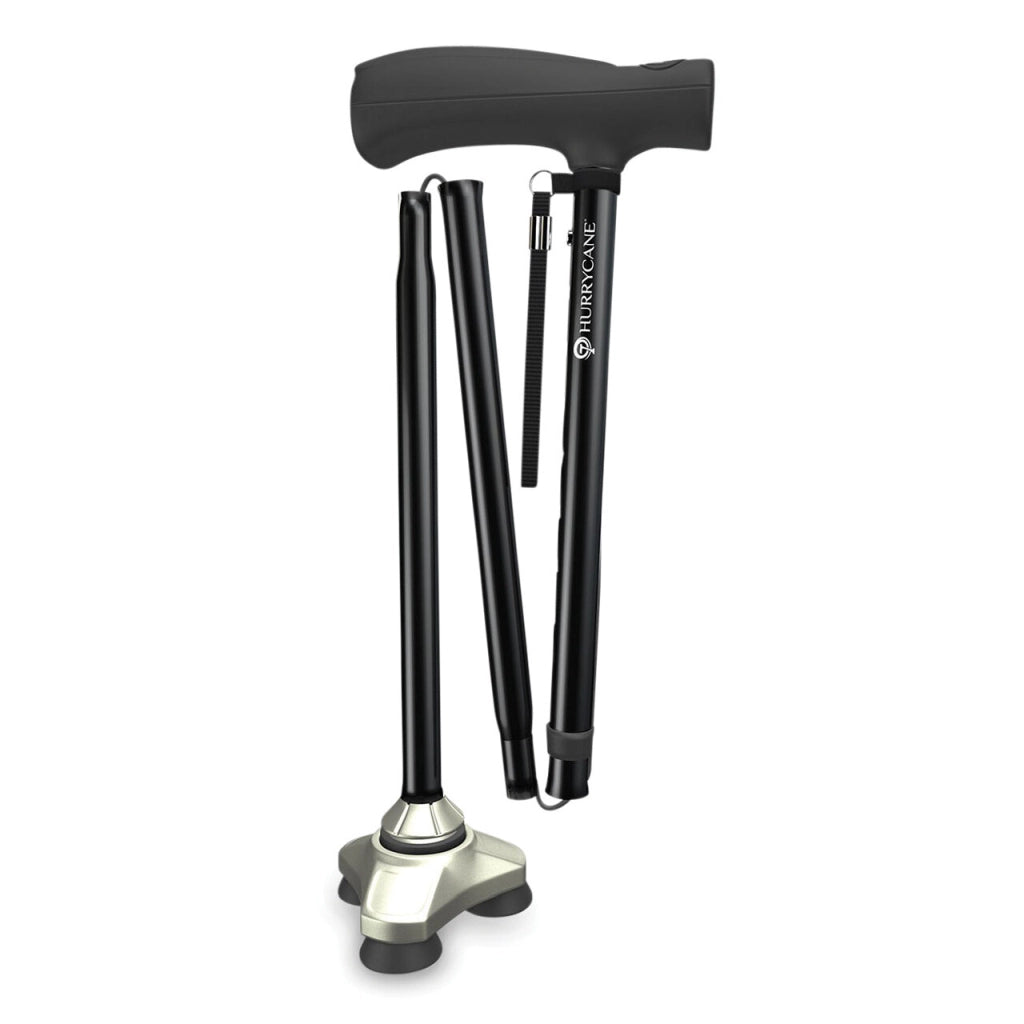 Zusammengefalteter Gehstock Hurrycane in Schwarz mit ergonomischem Griff, Handschlaufe und rutschfestem Dreifach-Standfuß – platzsparend und reisefreundlich.